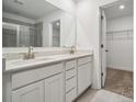 Double vanity bathroom with white cabinets and a walk-in closet at 307 Bezelle Ave, York, SC 29745