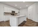 Modern kitchen featuring white cabinets, quartz countertops, and an island at 307 Bezelle Ave, York, SC 29745