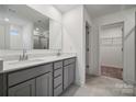 Bathroom with gray cabinets, double vanity, and a walk-in shower at 319 Bezelle Ave, York, SC 29745