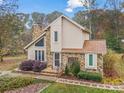 Beautiful front exterior highlighting a stone chimney, well-manicured landscaping, and a welcoming entrance at 33287 Mann Rd, Albemarle, NC 28001