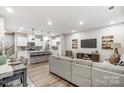 Open concept kitchen and living area with white cabinets and island at 4008 Cheyney Park Dr, Charlotte, NC 28269