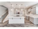 Modern kitchen with gray cabinets, quartz countertops, and island at 4016 Cheyney Park Dr, Charlotte, NC 28269