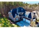 Two-story house with a three-car garage and wooded backyard at 407 Blue Bay Ct, York, SC 29745