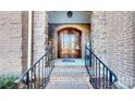 Double wooden doors and brick entryway with black railings at 407 Blue Bay Ct, York, SC 29745