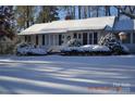 Charming ranch home with snow-covered lawn at 515 N Pine Ln, Wadesboro, NC 28170