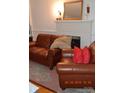 Cozy living room featuring a fireplace and brown leather furniture at 515 N Pine Ln, Wadesboro, NC 28170