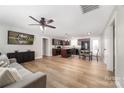 Open living room and kitchen with hardwood floors at 521 Summer Creek Dr, Stanley, NC 28164