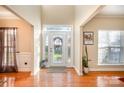 Bright entryway with hardwood floors and stained glass door at 5681 Berry Ridge Dr, Harrisburg, NC 28075