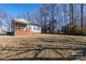 Gray siding house with brick base, wooden porch, and spacious backyard at 604 Kimball St, Kannapolis, NC 28081