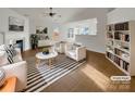 Virtually staged living room showcasing neutral tones, a fireplace, and built-in shelving at 811 Reigate Rd, Charlotte, NC 28262