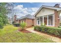 Brick home with sunroom and spacious backyard at 8355 Olde Troon Dr, Charlotte, NC 28277