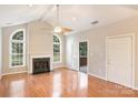 Spacious living room with hardwood floors, fireplace and high ceilings at 8355 Olde Troon Dr, Charlotte, NC 28277