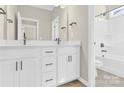 Bathroom with double vanity, white cabinets, and shower/tub combo at 9131 Nw Harwen Ne Ln # 32, Charlotte, NC 28215