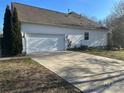 White vinyl-sided home with a two-car garage and driveway at 1004 Rosewater Ln, Indian Trail, NC 28079