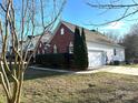 Brick house with attached garage and well-manicured lawn at 1004 Rosewater Ln, Indian Trail, NC 28079