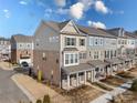 Two-story townhome with brick and siding exterior, offering a side view of the property at 11043 Lawyers Rd # 32, Mint Hill, NC 28227