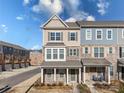 Attractive two-story townhome with light-colored brick and gray siding at 11043 Lawyers Rd, Mint Hill, NC 28227