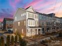 Two-story townhome with brick and siding exterior, showcasing a landscaped front yard at 11043 Lawyers Rd # 32, Mint Hill, NC 28227