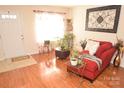 Living room with hardwood floors and red chaise lounge at 11646 Rabbit Ridge Rd, Charlotte, NC 28270