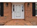 White front door with brick walkway and black shutters at 1212 Ridge St, Albemarle, NC 28001