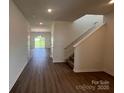 Bright entryway featuring wood-look floors leading to an open floor plan and staircase at 12131 Plummer Ct # 1, Midland, NC 28107