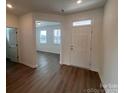 Inviting entryway with wood-look floors and a white door that complements the neutral wall colors at 12131 Plummer Ct # 1, Midland, NC 28107