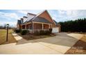 Brick home with a side view showcasing the attached garage and porch at 1270 Mirror Lake Rd, Lincolnton, NC 28092