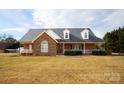 Brick ranch home with stone accents, a large front porch, and a landscaped yard at 1270 Mirror Lake Rd, Lincolnton, NC 28092