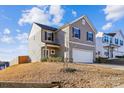 Two-story house with gray siding, attached garage, and landscaping at 128 Mooring Dr, Statesville, NC 28677