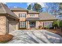 Two-story brick home with a metal roof and shutters at 15409 Brem Ln, Charlotte, NC 28277