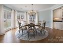 Elegant dining room with large windows, a chandelier, and ample seating for formal gatherings at 1915 Cavendale Dr, Rock Hill, SC 29732