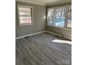 Living room with gray walls and wood-look flooring at 2505 Druid Hills Way, Charlotte, NC 28206