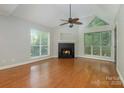 Bright living room with hardwood floors, fireplace, and vaulted ceiling at 2514 Cranbrook Ln # 5, Charlotte, NC 28207