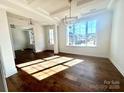 Bright dining room with hardwood floors and a large window at 2558 Red Hill Nw St # 51, Concord, NC 28027