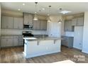 Island kitchen with gray cabinets and granite countertops at 2632 Tillman St, Monroe, NC 28112