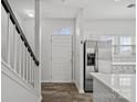 Bright entryway with hardwood floors, white door, and staircase at 3026 Uxbridge Woods Ct, Charlotte, NC 28205