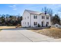 Large two-story white brick house with a long driveway and landscaped yard at 303 S Greene St, Wadesboro, NC 28170