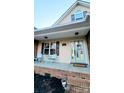 Inviting front porch with light blue door, two chairs, and a welcoming atmosphere at 306 Bluegill Ln, Statesville, NC 28625