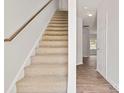 Carpeted staircase with wood railing leading to upper level at 3148 Ora Smith Rd, Lincolnton, NC 28092