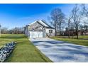 House exterior showcasing stone accents and a two-car garage at 335 Pinewood Ln, Rock Hill, SC 29730