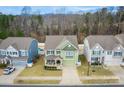 Aerial view of a green house and surrounding homes at 3836 Lake Breeze Dr, Sherrills Ford, NC 28673