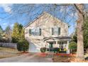 Two-story house with beige siding, green door, and attached garage at 4210 Saguaro Ct, Charlotte, NC 28269