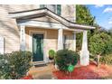 Inviting front porch with green door and landscaping at 4210 Saguaro Ct, Charlotte, NC 28269