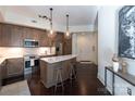 Modern kitchen with stainless steel appliances and a large island at 4620 Piedmont Row Dr # 504, Charlotte, NC 28210