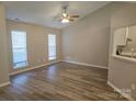 Bright living room with a ceiling fan, light colored walls, and wood-look flooring at 4630 Sw Falcon Chase Sw Dr, Concord, NC 28027