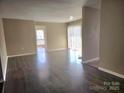 Spacious living room with hardwood floors and access to balcony at 4902 Spring Lake Dr # E, Charlotte, NC 28212