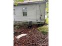 Slightly unkempt backyard with debris and a chicken coop at 517 Ashford St, Chester, SC 29706