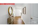 Light-filled hallway showcasing hardwood floors and decor at 553 Zermatt Ct, Monroe, NC 28112