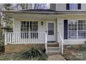 Front view of townhome with white porch and stairs at 6411 Windsor Gate Ln, Charlotte, NC 28215