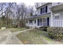 Townhome exterior showcasing a front porch and landscaping at 6411 Windsor Gate Ln, Charlotte, NC 28215